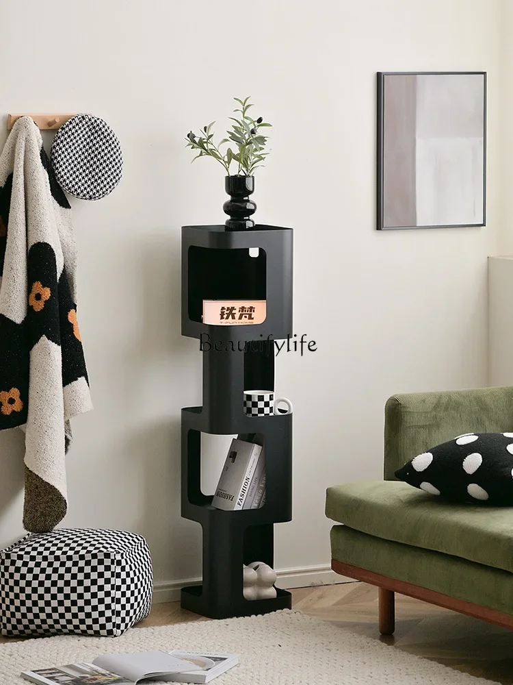 Small bookshelf by wrought iron wall Steel bookcase turns corner cabinet against wall Living room floor shelf