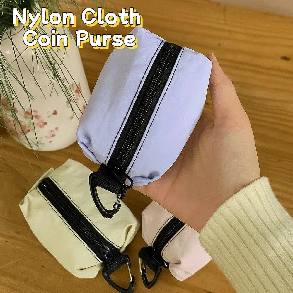 Monedero portátil de tela de nailon, estilo coreano, gran capacidad, cremallera, bolsa para artículos pequeños, bolsa de cosméticos ligera de Color sólido para auriculares
