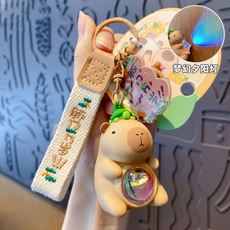 Creative Luminous Capibala Doll Key Chain Cute Green Turtle Lying OnTthe Head Buddha Capybara Dream Sunset Light Keychain Toy