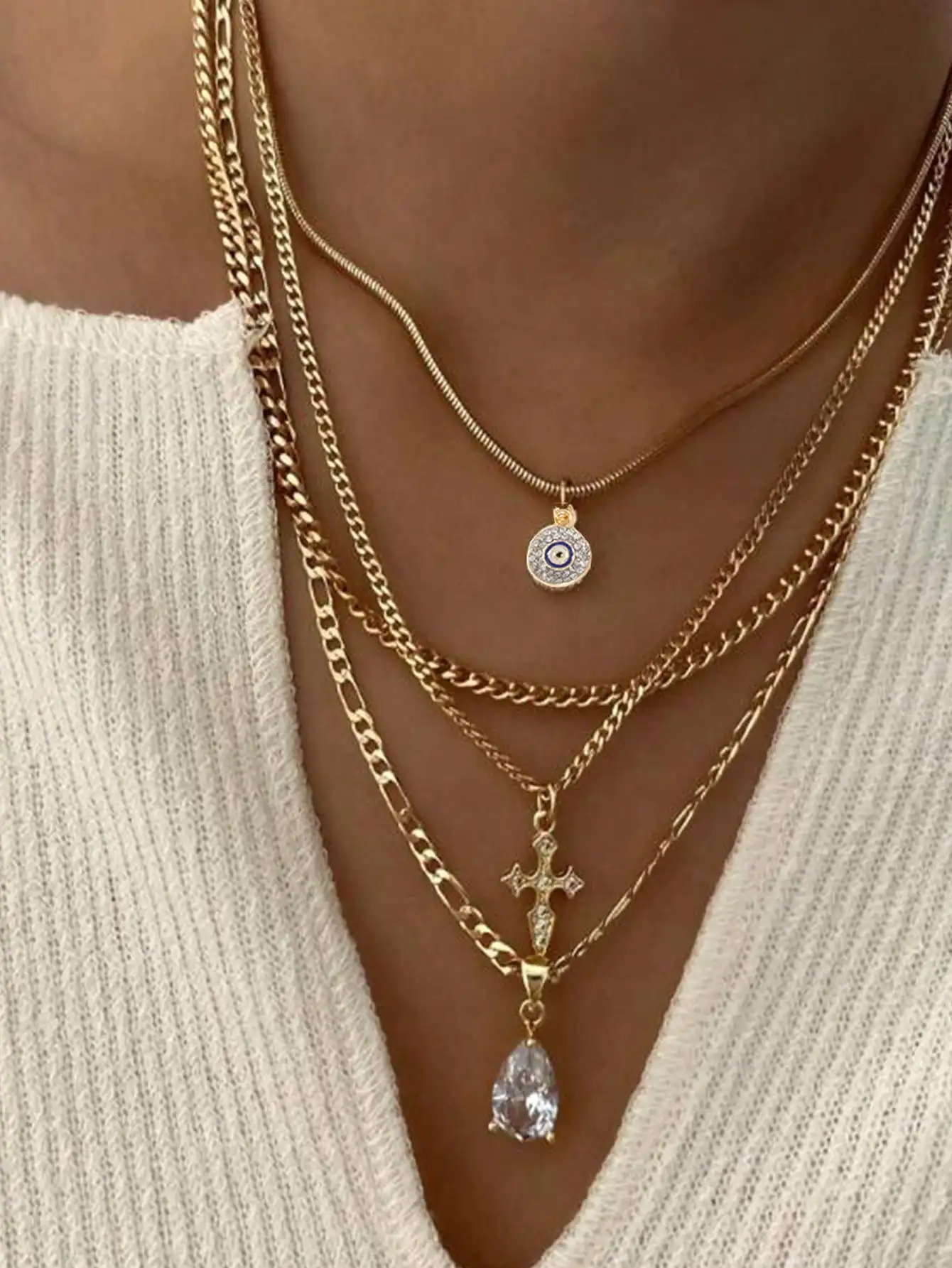 

Набор из 4-х многослойных золотистых ожерелий с подвесками в виде злого глаза, креста и капли.