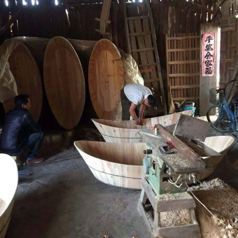Fish basin fishing boat hand rowing wooden boat basin boater rowing fishing under the net fishing wooden boat under