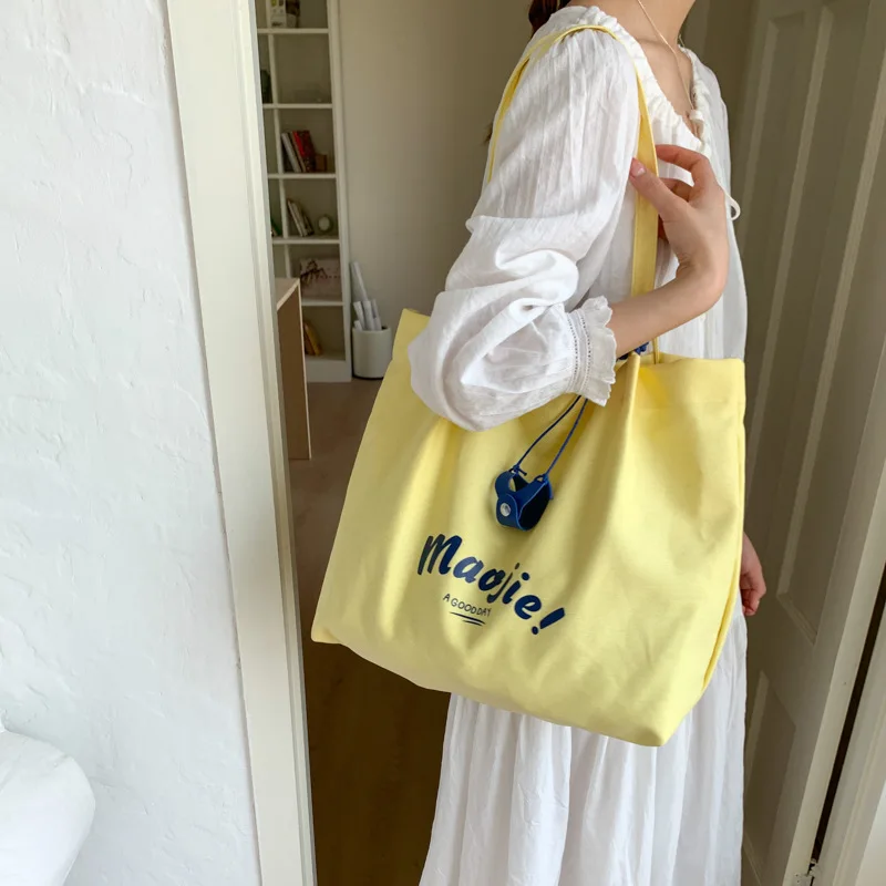 

Summer leisure large capacity high sense to work commuter tote bag women's 2026 new alphabet canvas hand bag