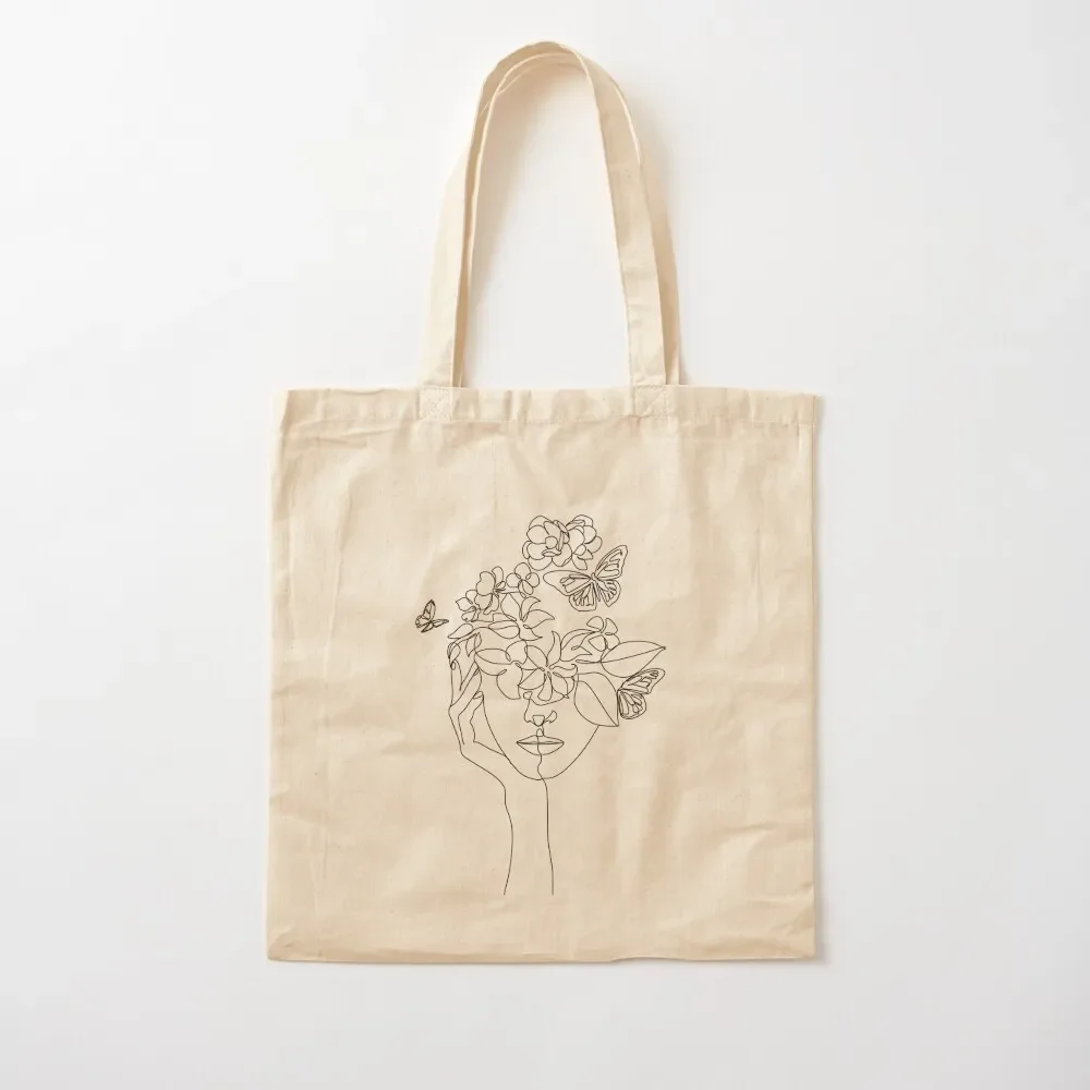 

Abstract face with flowers by one line vector drawing. Portrait minimalistic style. Botanical print. Nature symbol of c Tote Bag