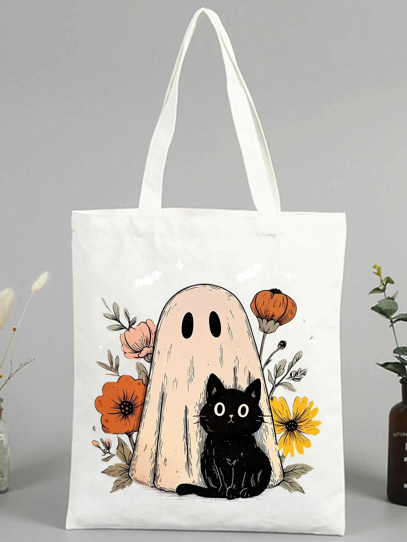 Women's canvas tote bag with ghost and black cat graphic, ideal for casual outings and Halloween events