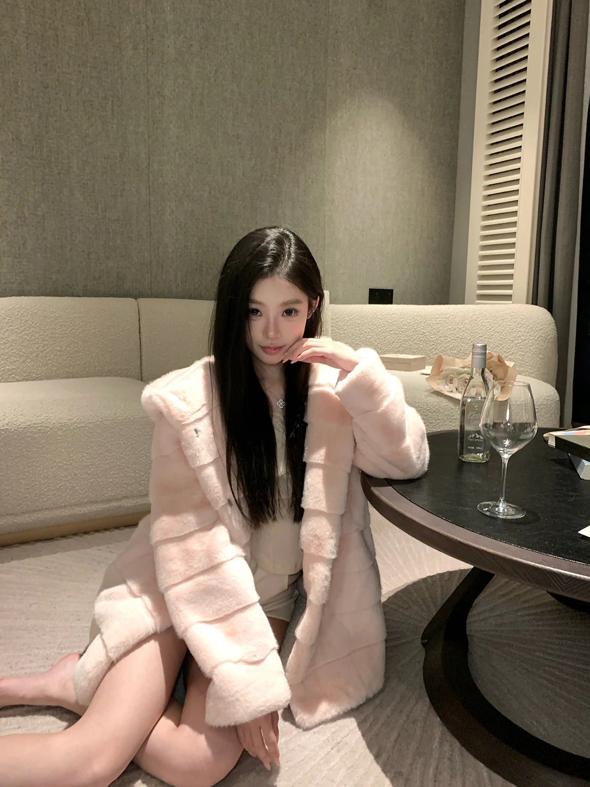 A mid-length eco-friendly faux mink fur coat for women with a fixed dyeing and hooded look