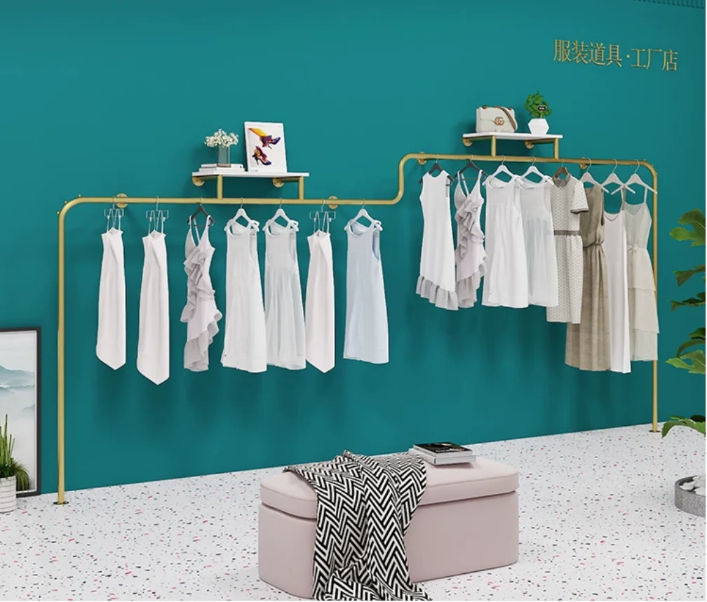 Wall mounted golden display rack on clothing store shelves, specifically designed for women's clothing stores