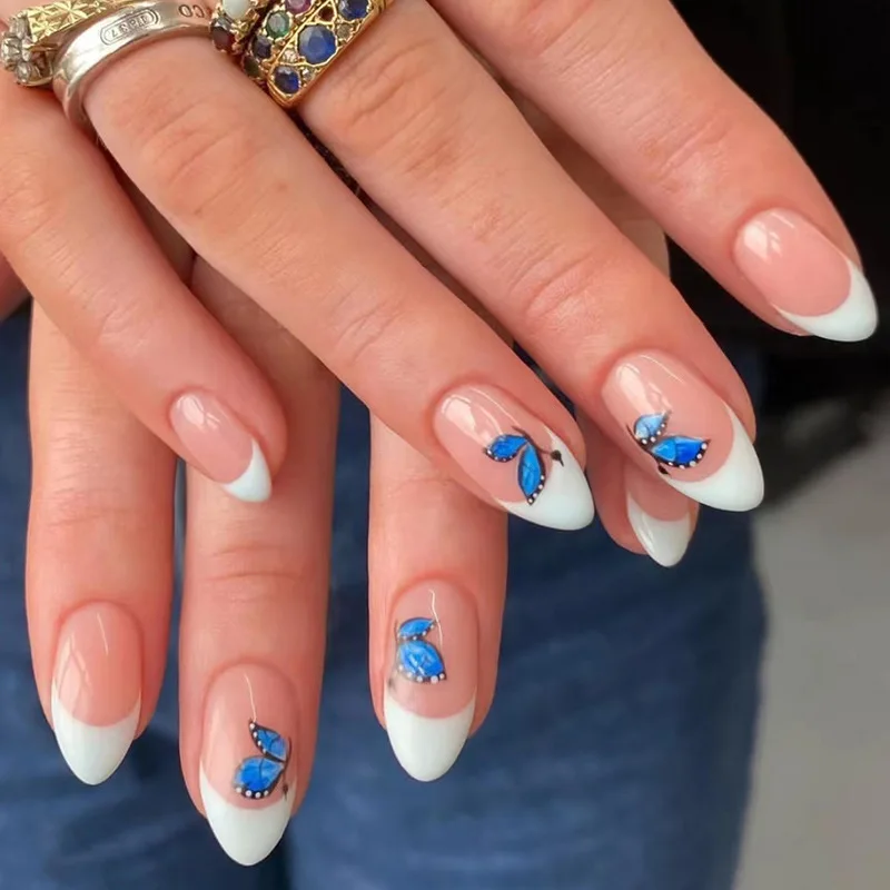 

24Pcs Short Almond Press-on Nails: Sheer Pink Base with White Stiletto Tips & Blue Butterflies - Unique & Delicate