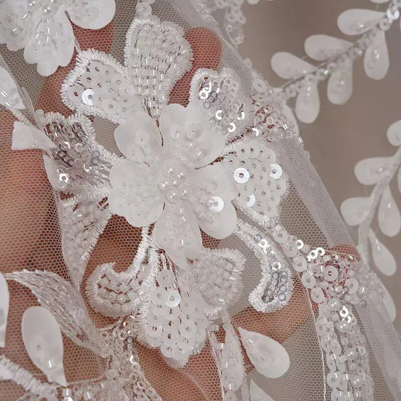 

New white sequin flower beaded tweed fabric ideal for wedding gowns outerwear and dresses adding a touch of glamour