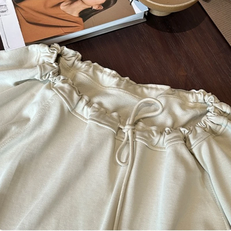 เสื้อยืดผู้หญิงคอเฉียง แขนยาว สไตล์เกาหลี ลำลอง หลวม ผูกเชือก รุ่นใหม่ ปี 2025 สำหรับฤดูใบไม้ผลิและฤดูใบไม้ร่วง