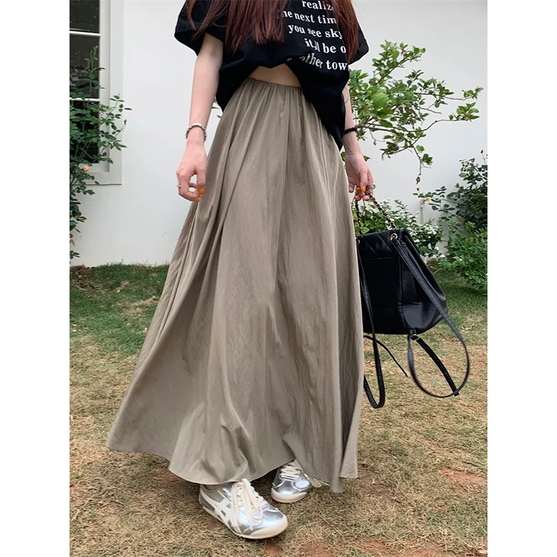 Minimalis wanita Boho elastis pinggang tinggi A-Line Flowy Swing asimetris Tiered rok panjang Maxi gaun kasual longgar Solid