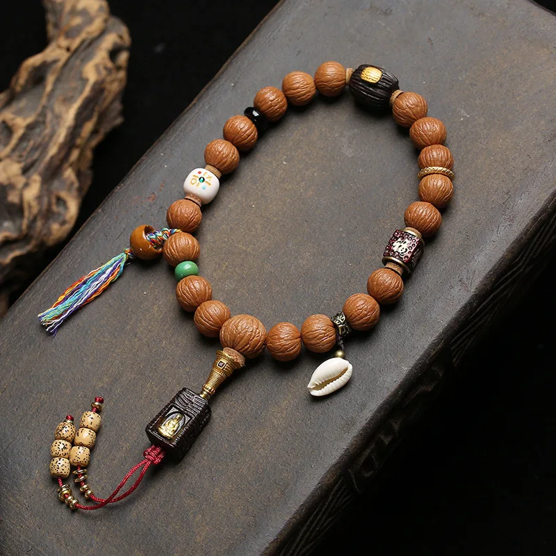 

Natural, untreated monkey head bodhi wood collectible with a jade-like patina, featuring sandalwood, agate and shell accents