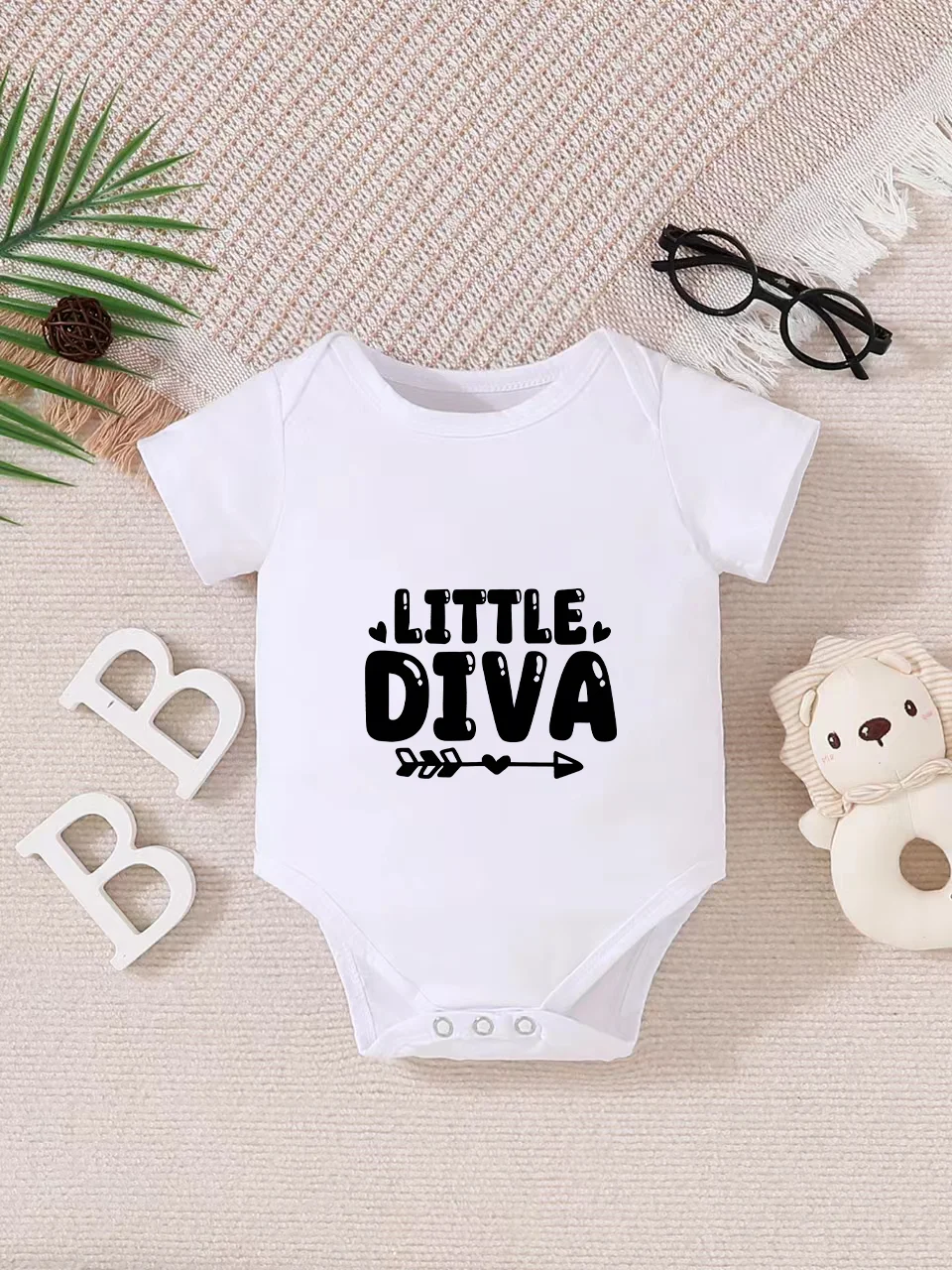 Playful letter-printed baby short-sleeve triangle bodysuit. Button closure for easy dressing, machine washable