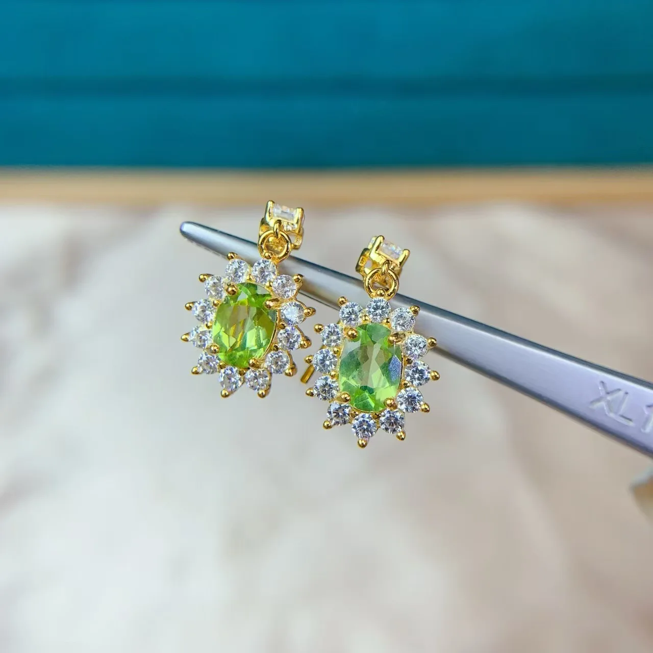 Natural peridots earrings fully clear high-quality dazzling green color featuring a precisely set main stone measuring 57mm