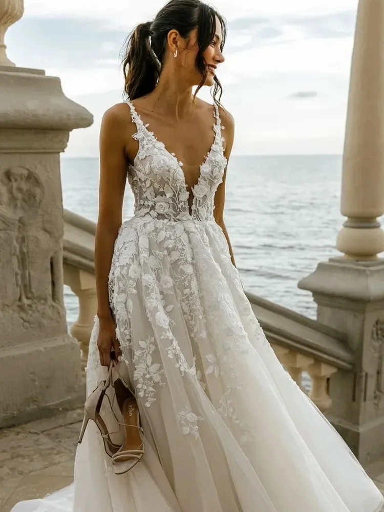 Sexy and Elegant, Deep V-Neck Gown featuring Sheer Tulle and Lace Appliqués — An Open-Back Wedding Dress with a Seaside Vibe