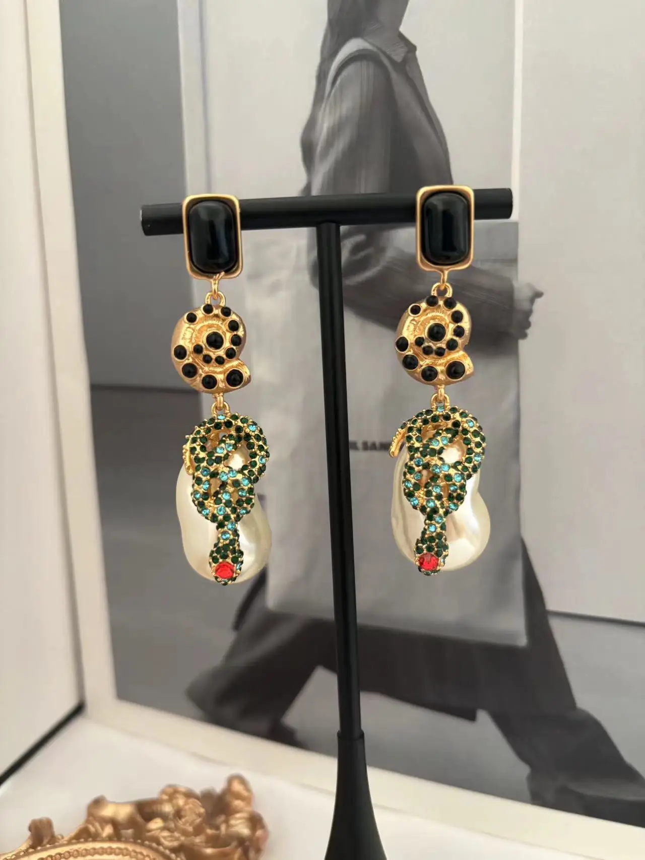 

Schiaparel style snake-shaped Baroque pearl earrings, vintage French face art, old money