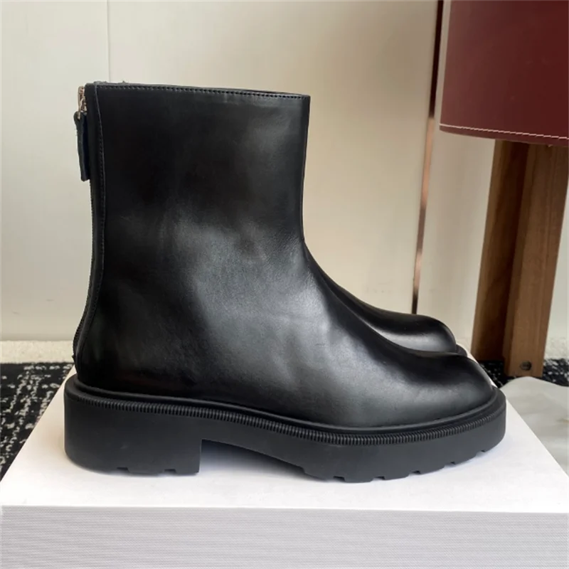 

New and nude boots Almond-shaped toe Made of calf leather Features a rubber block heel and lug non-slip sole Tonal zippered leat