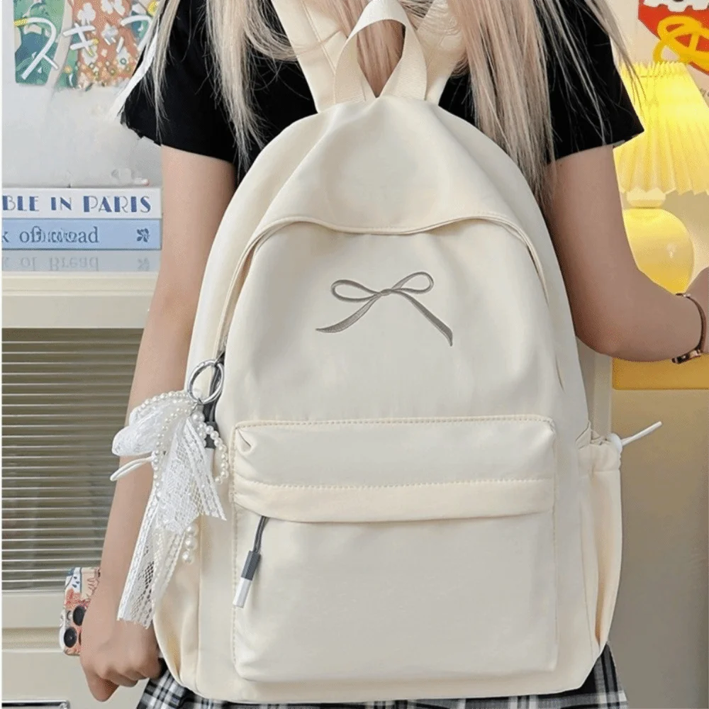 حقيبة ظهر محمولة مطرزة على شكل فيونكة للفتيات من النايلون بلون سادة حقيبة مدرسية للطلاب خفيفة الوزن ذات سعة كبيرة حقيبة ظهر للسفر