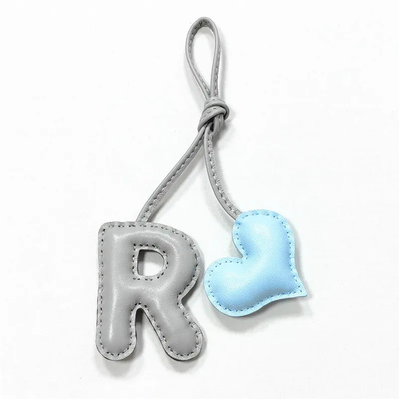 Genuine leather R with heart-shaped letter style bag decoration with pure handmade stitching, high-end car keychain accessories