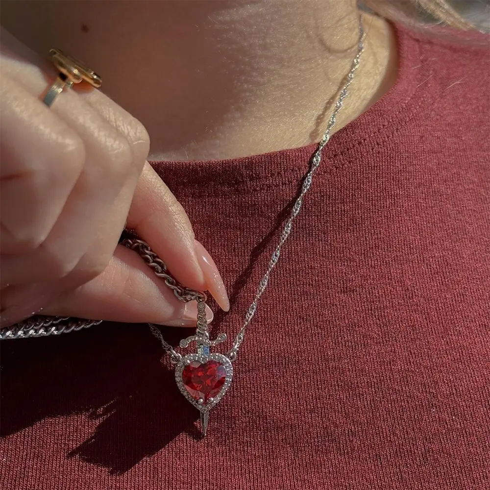 Silver Twisted Chain Necklace, Sword Pierced Heart Pendant with Large Heart-Shaped Red Crystal Surrounded by Clear Rhinestone Halo, Gothic Y2K Dark Romantic Statement Jewelry
