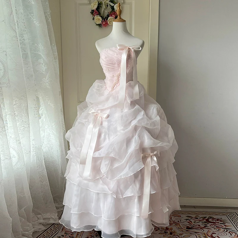 AnXin SH เจ้าหญิงดอกไม้สีชมพูลูกไม้เกาะอกแขนกุดประดับด้วยลูกปัดมุกโบว์รัฟเฟิลบอลชุดผูกเชือกชุดแต่งงานที่กำหนดเอง