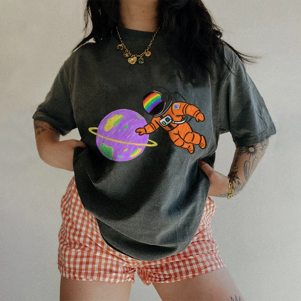 

Vintage Washed Astronaut Graphic T-Shirt Retro Space Tee with Rainbow Helmet Purple Planet Design Casual Whimsical Style
