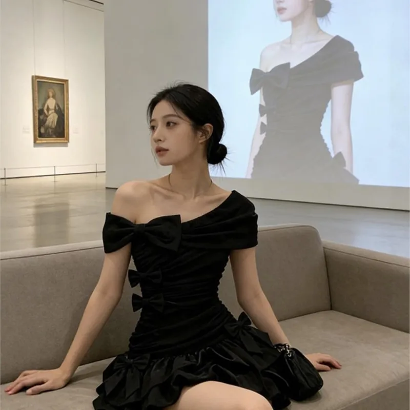 A large-sized black off-the-shoulder elegant cinched-waist short skirt