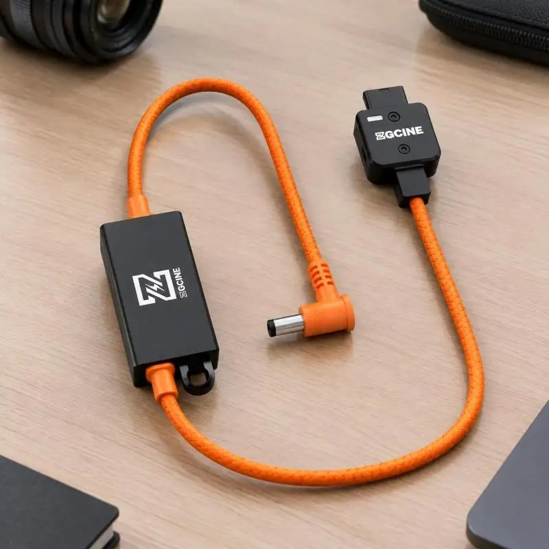 31BA D-Tap Camera Power Cable with 19.5V Delivery, Orange-and-Black Exterior, Integrated Regulation, and Aluminum Housings on