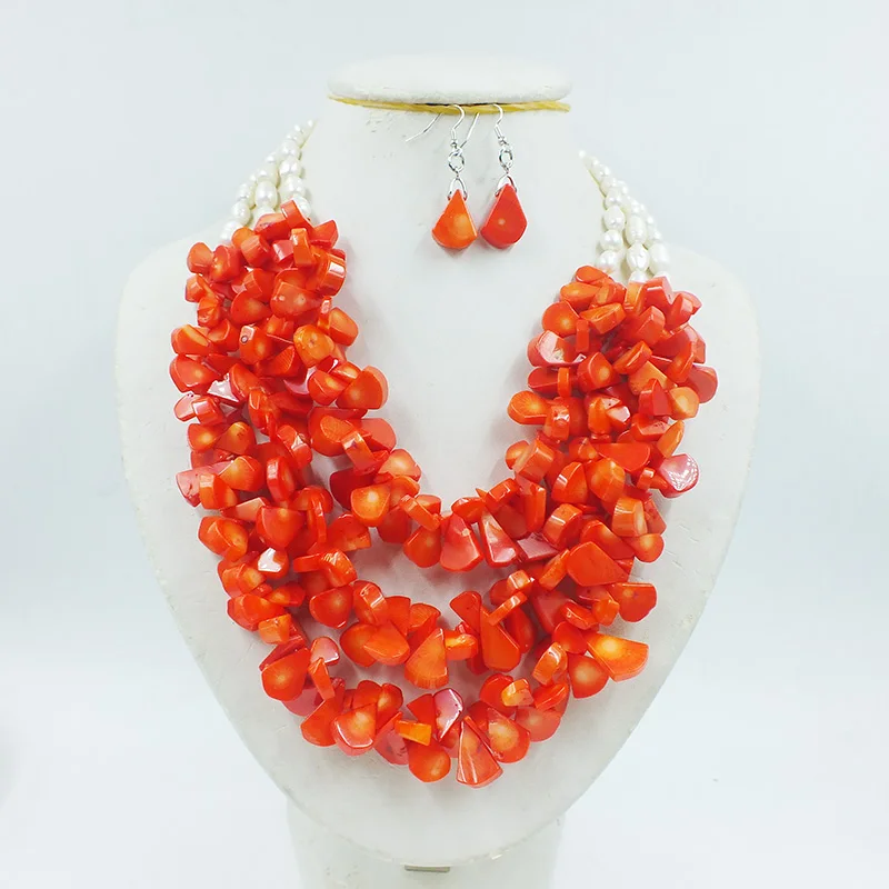 

3 rows of natural orange coral/natural pearls. African Women Wedding Necklace/Earrings Set 18-25”