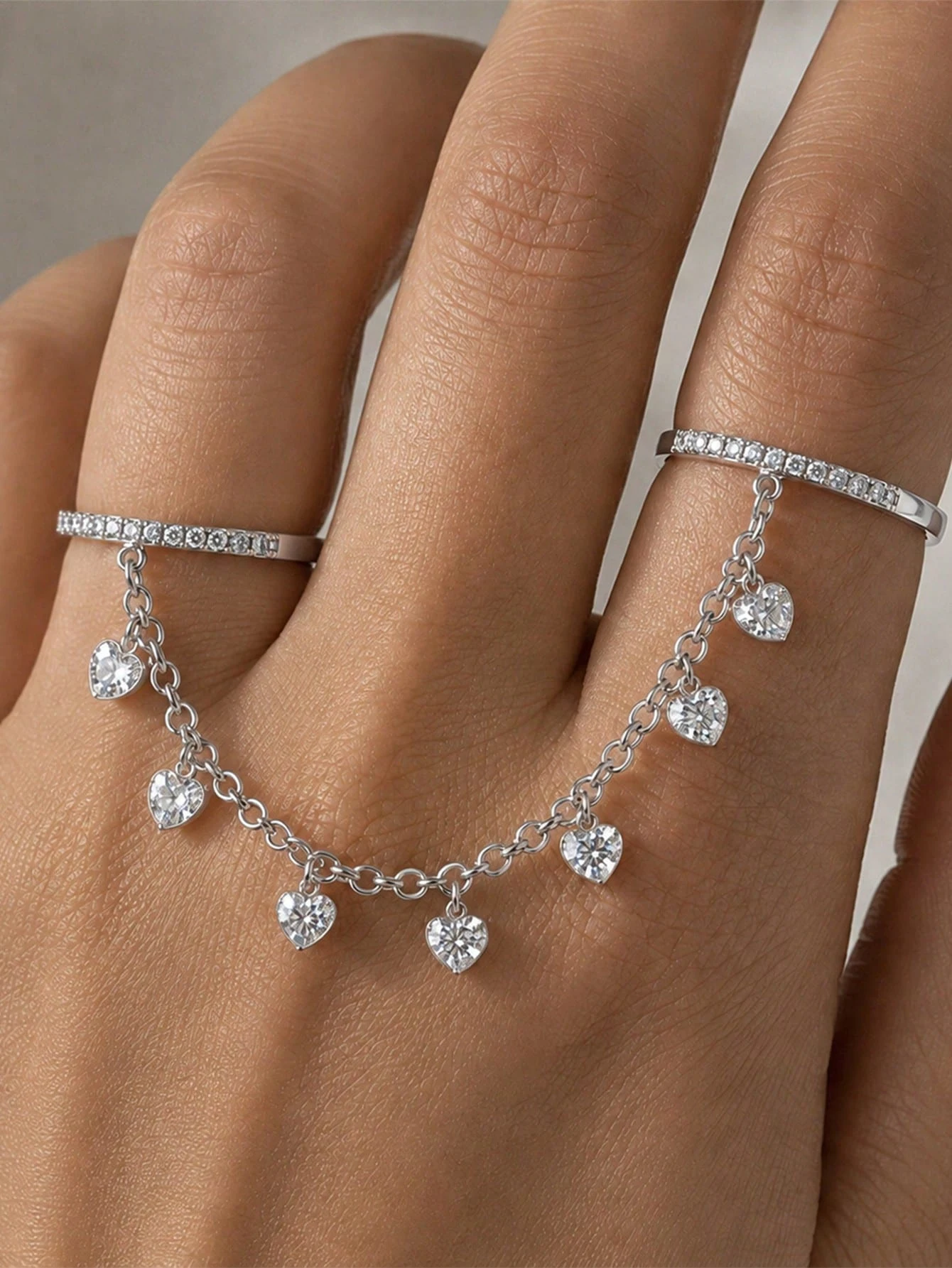 A minimalist, stylish, and versatile women's ring featuring a heart design and tassels—perfect for evening wear.