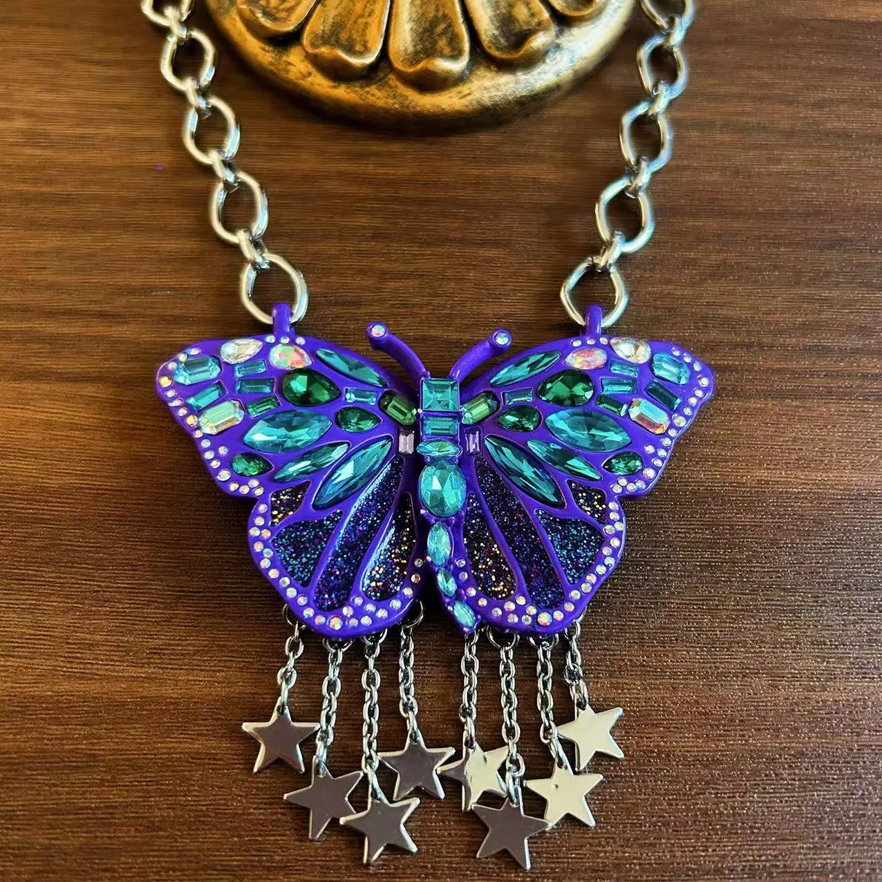 exaggerated butterfly necklace with blue tassels