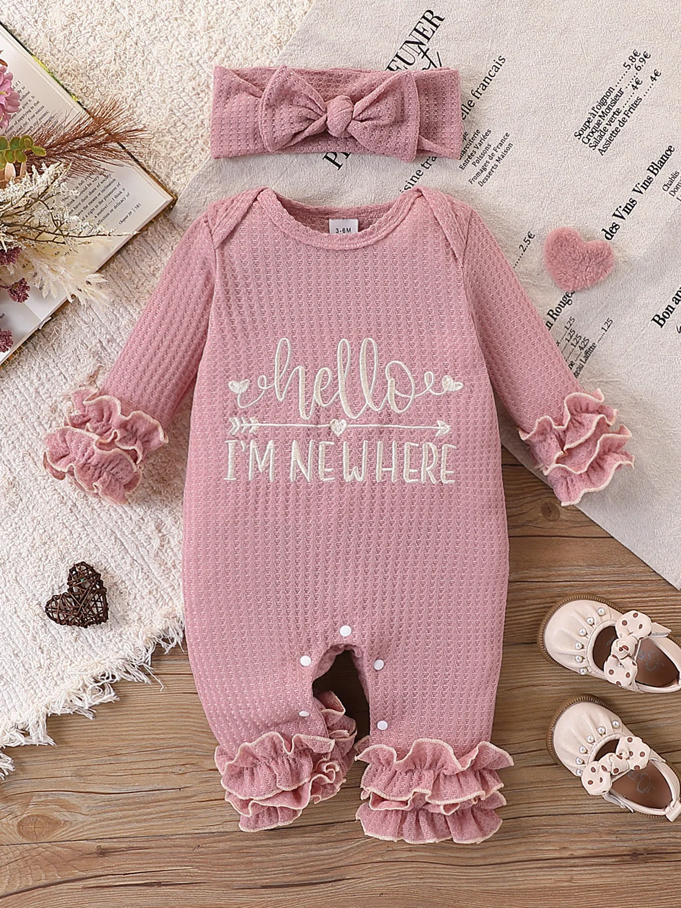 Newborn Baby Girl Waffle Knit Ruffle Romper Set – “Hello I’M New Here” Embroidered Letters, Multi-Layered Sleeves and Ruffles on the Feet, Snap Crotch Closure, Soft Hospital Discharge/Daily Sweet Romper + Matching Color Bow Headband