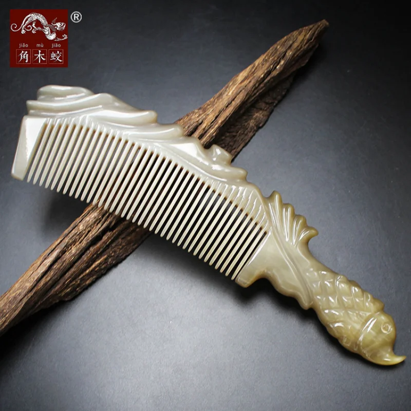 Carved fish-shaped comb made from hornwood and yak horn