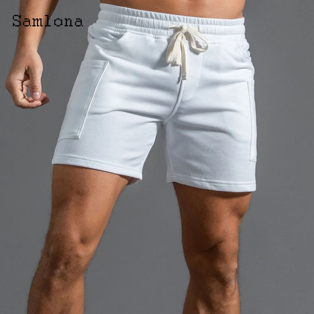 2025 ฤดูร้อนใหม่กางเกงขาสั้นสบายๆผู้ชายเซ็กซี่เอวยางยืดกางเกงขาสั้นชายขาตั้งกระเป๋าฟิตเนสชายหาดสั้นกางเกงสีเทาสีขาว