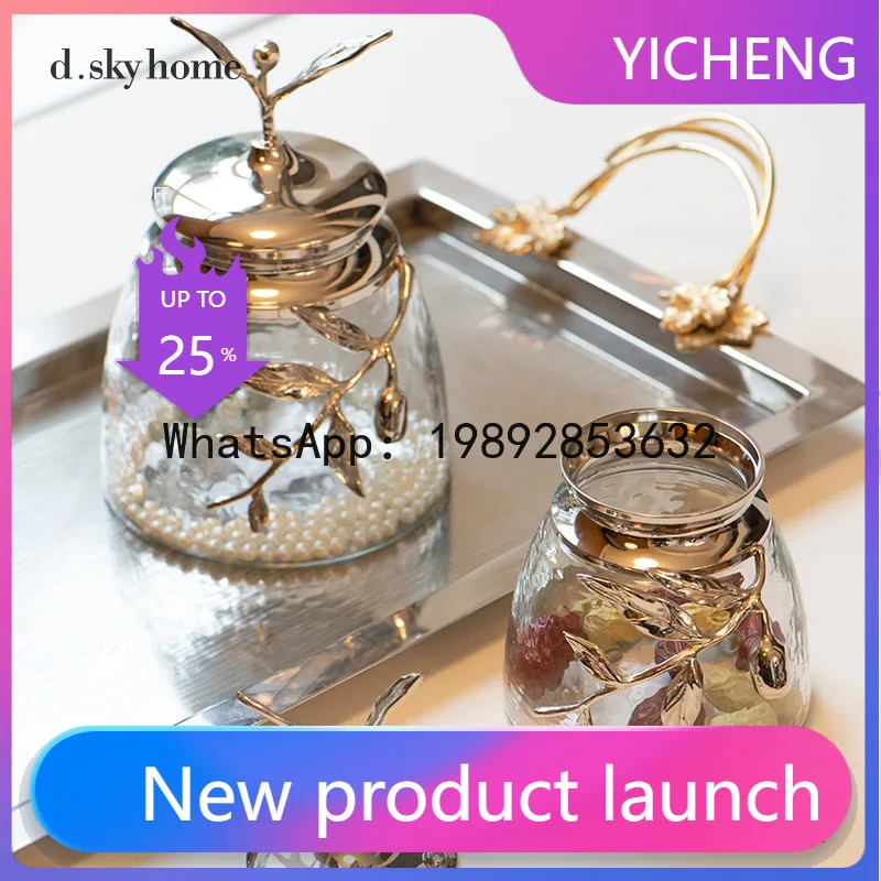 

Hys brass modern style glass jar with metal lid and branch & leaf accents