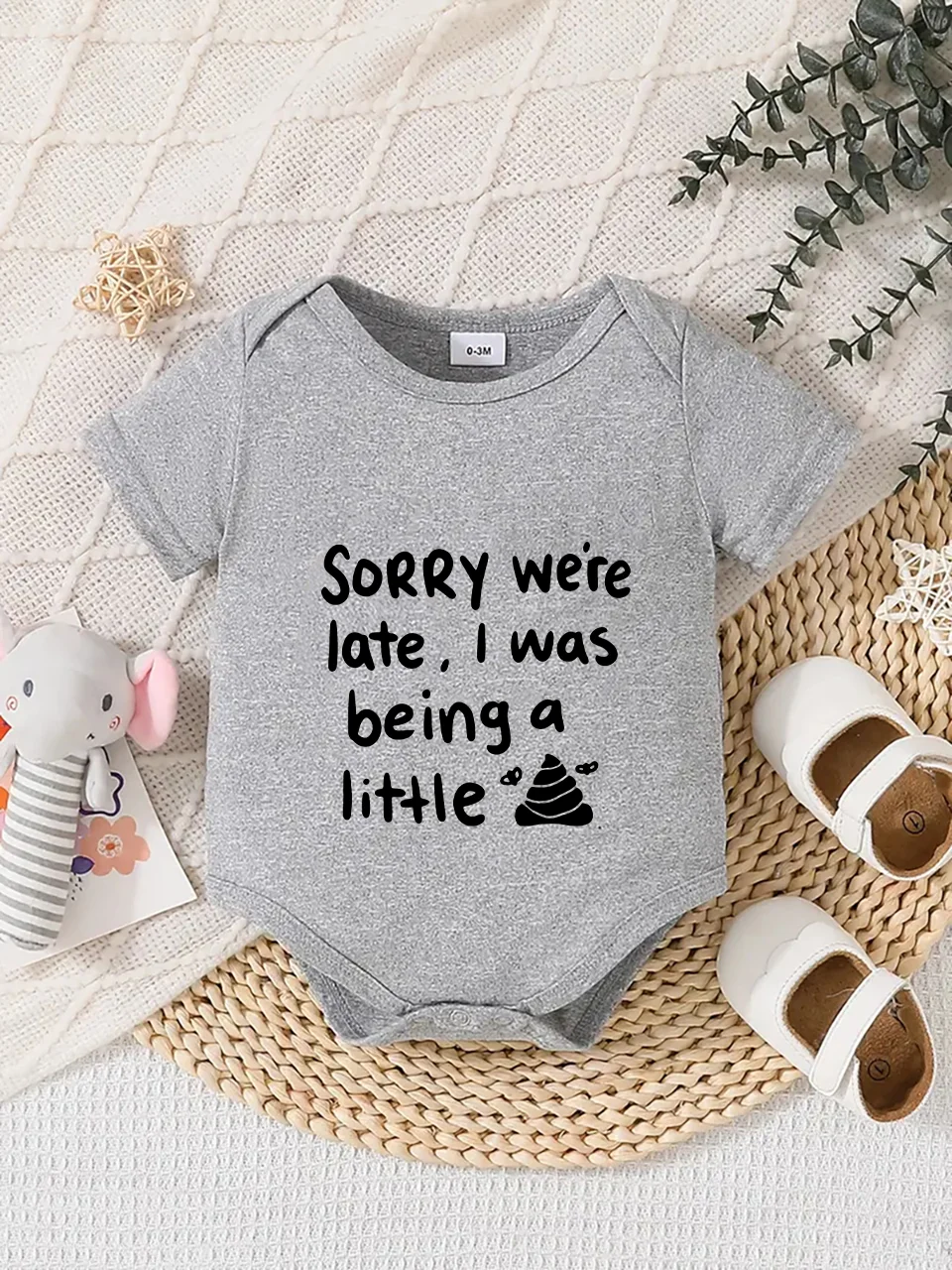 Playful letter-printed baby short-sleeve triangle bodysuit. Button closure for easy dressing, machine washable