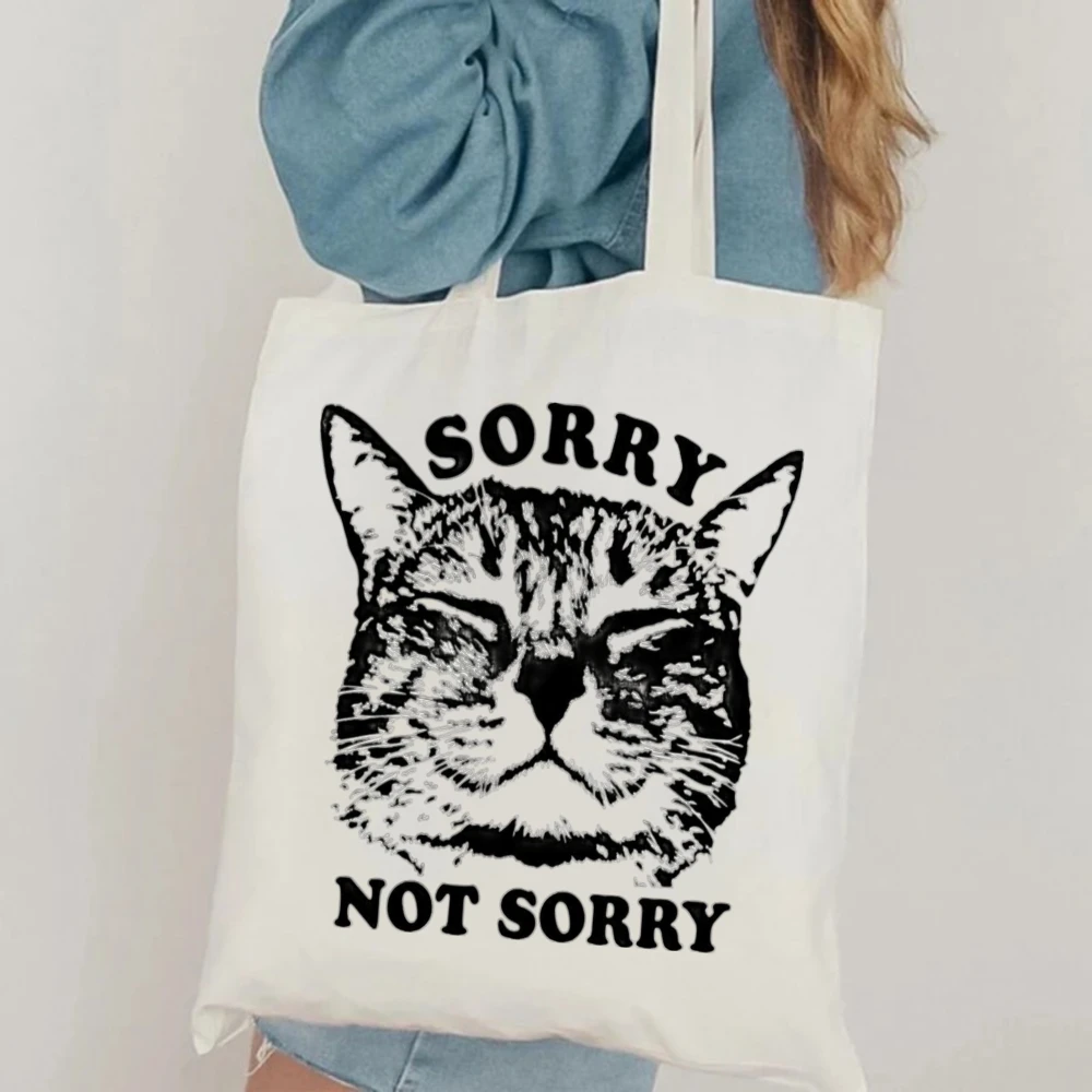Funny "Sorry Not Sorry" Cat Graphic Canvas Tote Bag Casual White Shoulder Bag with Sassy Cat Quote Print for Daily Use White