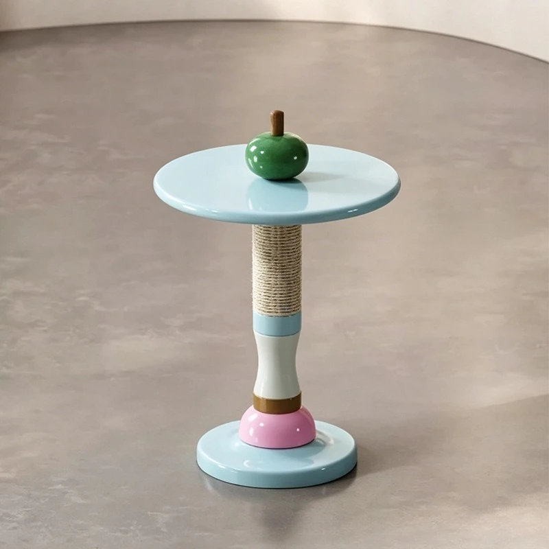 Table people and pets share a small table with a few candied gourds on the edge of the cat scratching column