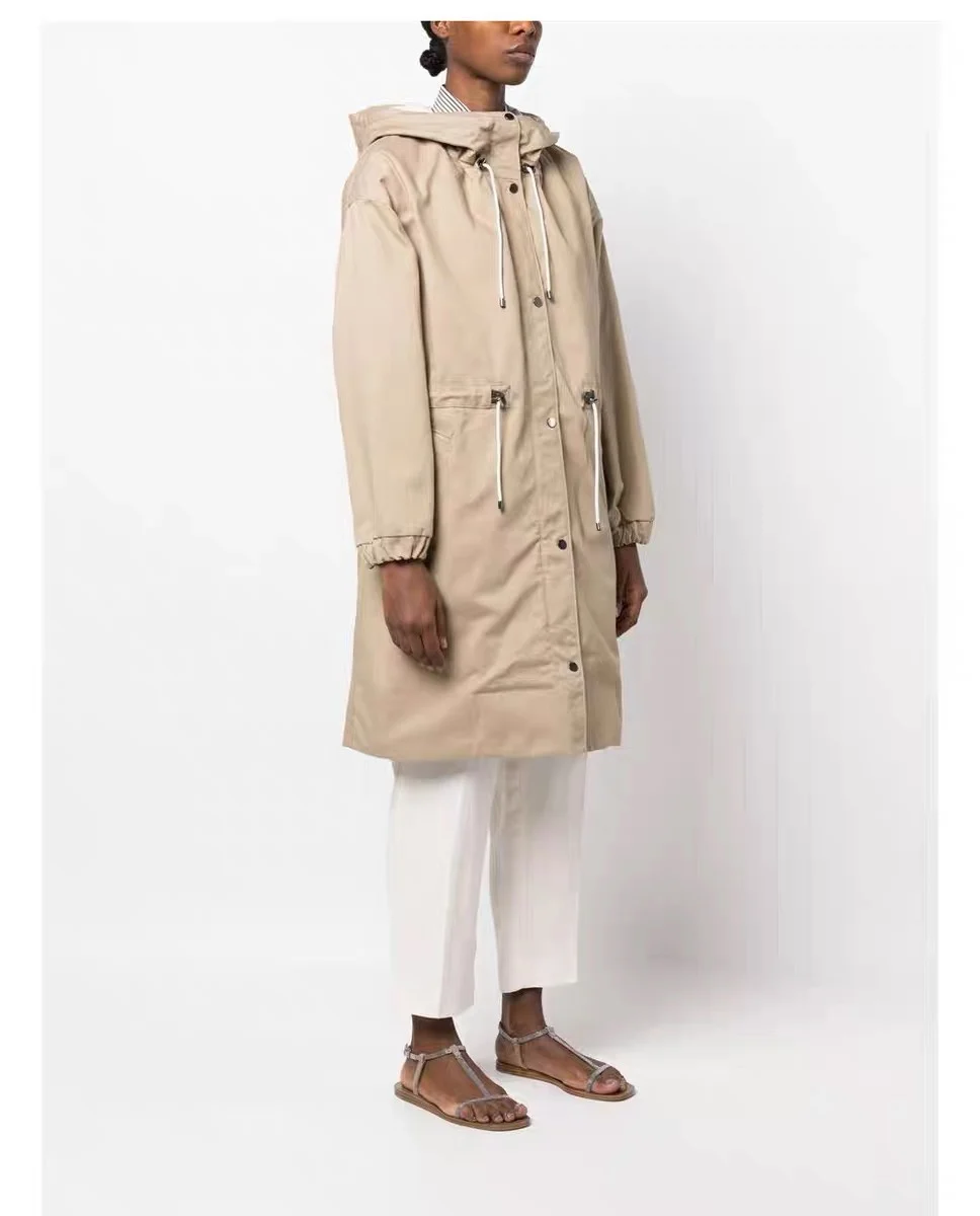 

Women's three-dimensional silhouette cut long windbreaker coat with a studded buckle and drawstring waist closure design