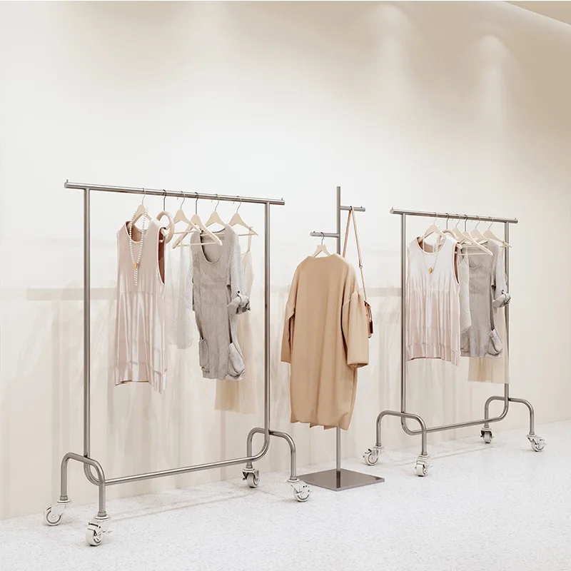 Clothing store display rack, floor standing clothes hanging pole, stainless steel brushed silver with wheels, women's