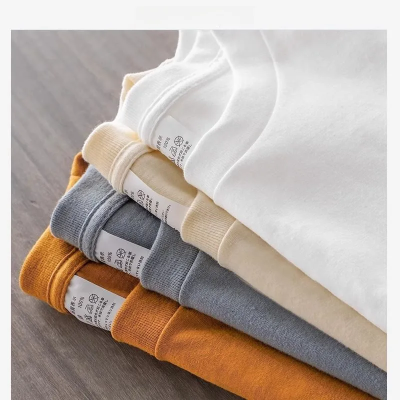 قميص أبيض بأكمام طويلة من القطن الخالص ثقيل الوزن برقبة مستديرة قميص أساسي للارتداء الداخلي بأسلوب عادي مريح يناسب جميع المواسم