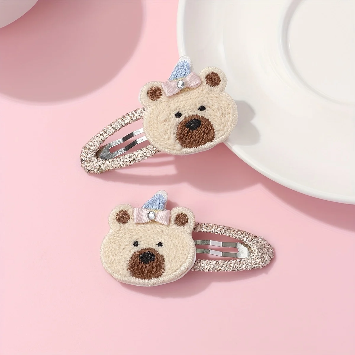 

A set of two hair clips featuring cute rabbit, bear, and deer designs. Made with laser cutting and computer embroidery details, the clip is covered with scratch resistant fabric for hairstyle design.