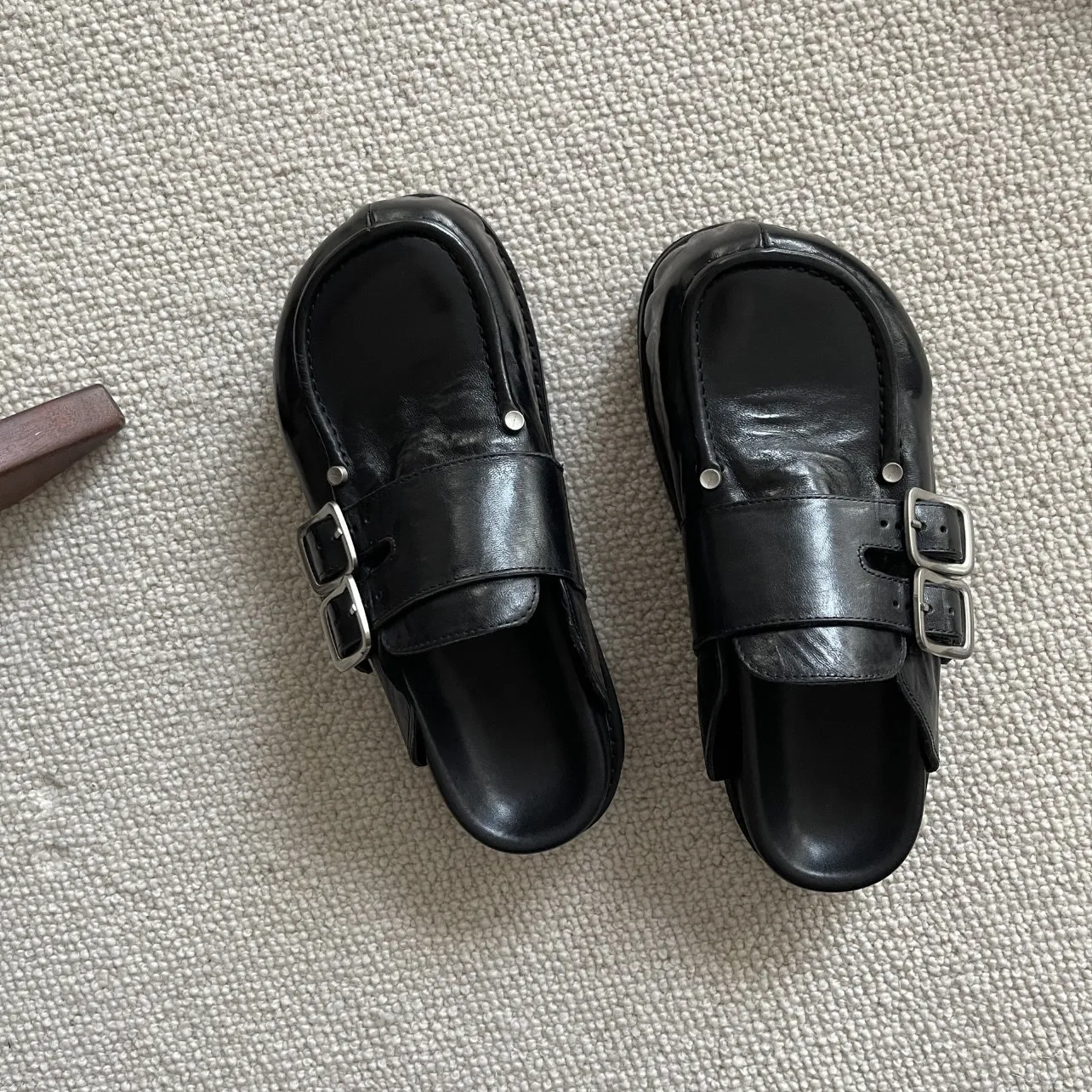 

Unisex Black Leather Platform Mules Double Buckle Strap with Stud Detail for Pun Grunge & Minimalist Fashion Statements