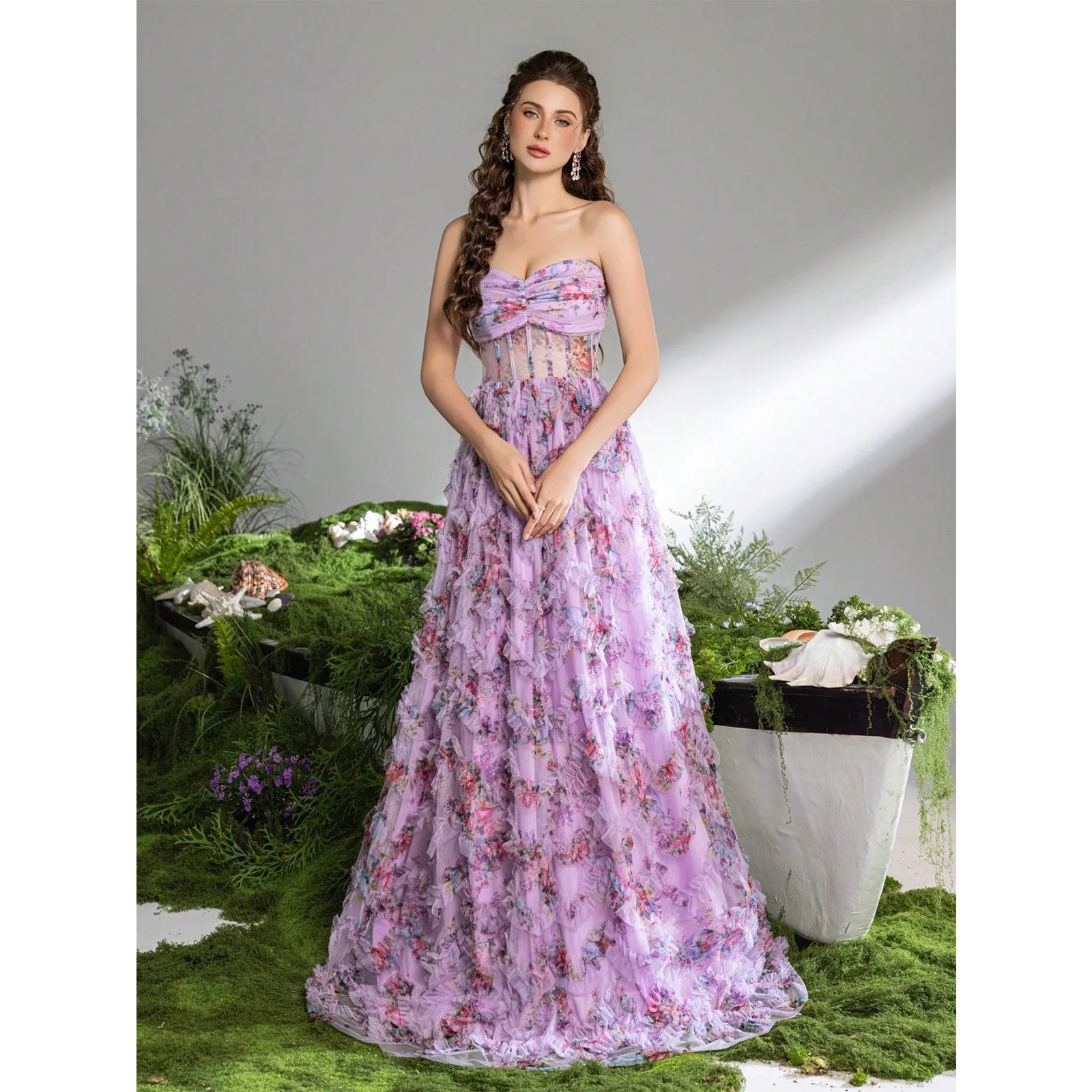

An elegant strapless A-line evening dresses with a gathered bust, adorned with floral prints and cascading ruffles 2026