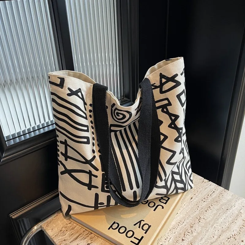 ファッションプリントストライプキャンバスバッグ、大容量裏地ハンドバッグ、キャンパス学生バックパック、若者の日常ショッピング文学用途