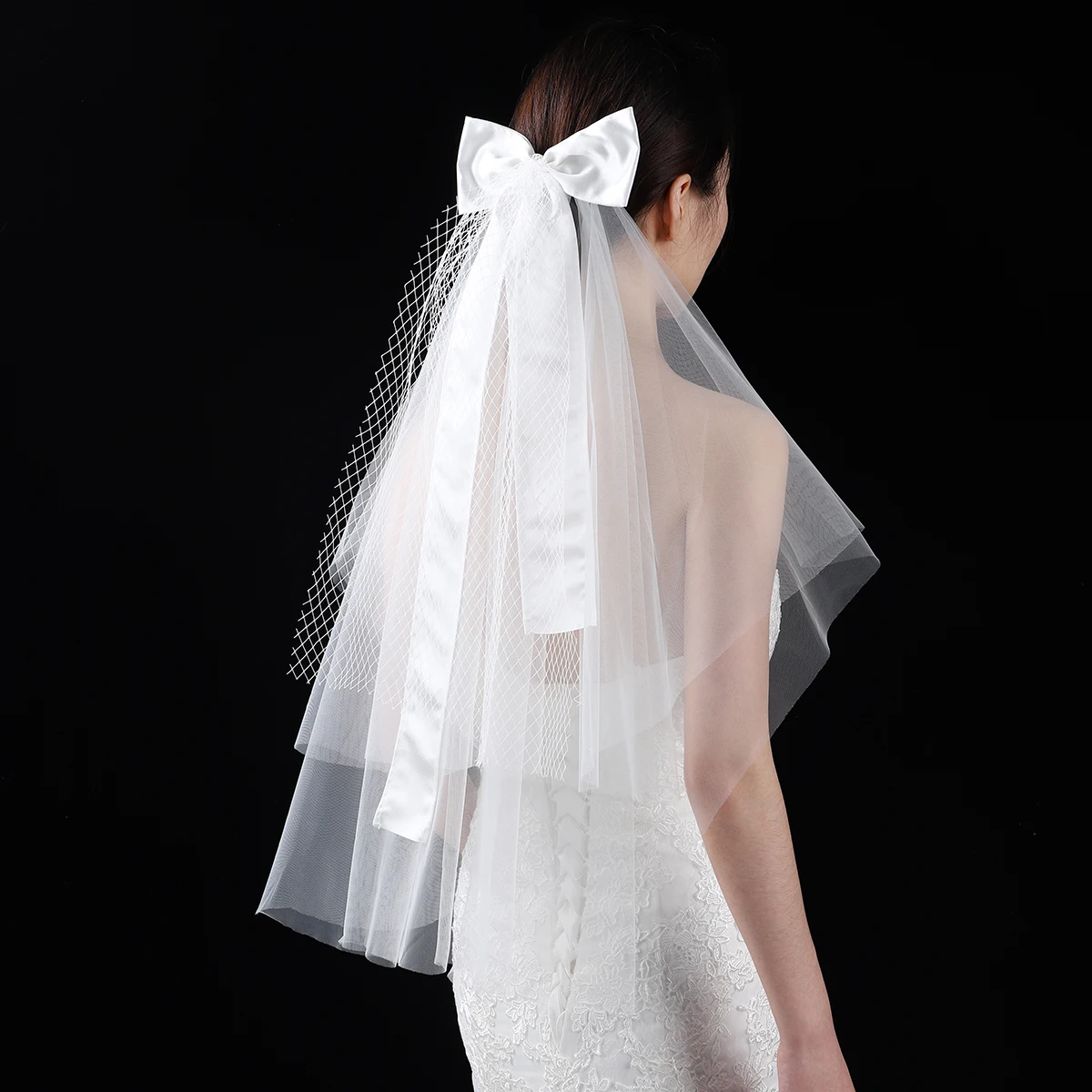 A white elegant bridal veil adorned with a simple bow, waist length veil suitable for women's weddings