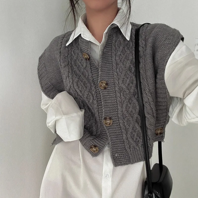 

The sleeveless vest is a versatile grey round-neck knitted waistcoat with a literary style and twisted buttons for women