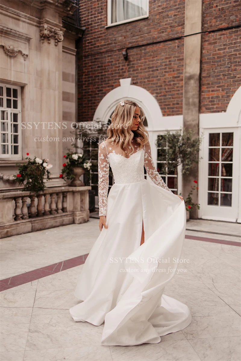 ชุดแต่งงานทรงเอไลน์สุดหรูจาก SSYTENS สีขาว ประดับด้วยลูกไม้ แขนยาวแบบซีทรู  ชุดเจ้าสาวแบบคอร์เซ็ทสั่งตัดได้ ปี 2026