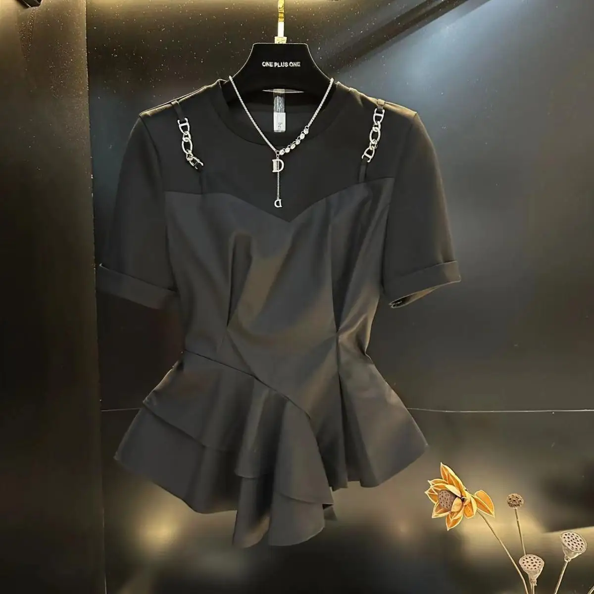 Black blouse female 2024 summer new irregular design slim Joker fake two-piece short-sleeved T-shirt with ruffled stitching.