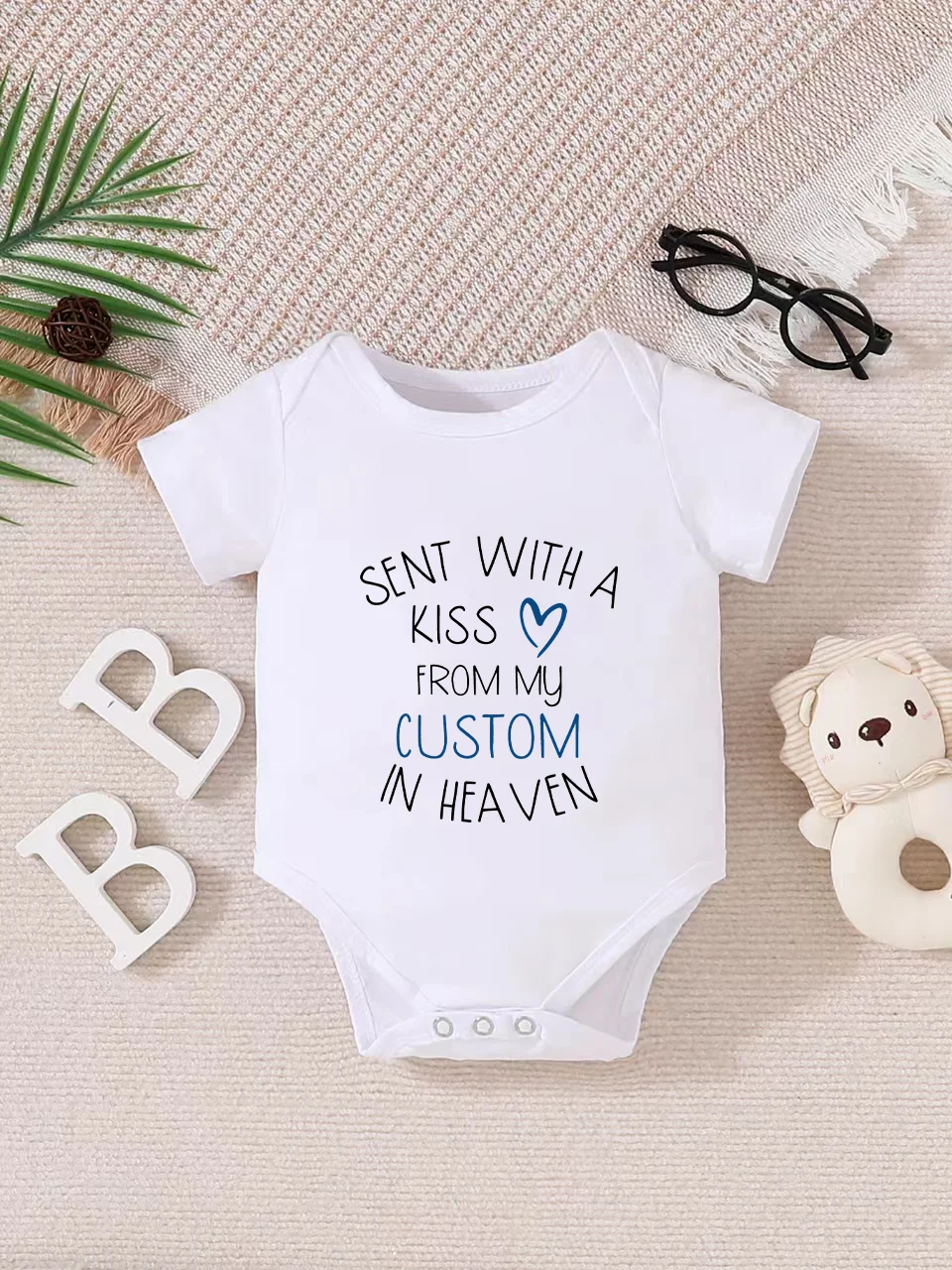 

Playful letter-printed baby short-sleeve triangle bodysuit. Button closure for easy dressing, machine washable