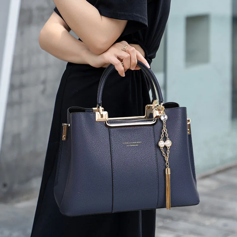 

Aidrani Fashionable women's handbag in blue with large capacity made of high-quality cowhide and equipped with metal tassels